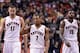 Jan 1, 2014; Toronto, Ontario, CAN; Toronto Raptors point guard Kyle Lowry (7) and center Jonas Valanciunas (17) and power forward Amir Johnson (15) react to a play during the fourth quarter of a game at the Air Canada Centre. Toronto won the game 95-82.