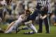 Nov 30, 2013; Morgantown, WV, USA; Iowa State Cyclones defensive end Willie Scott (50) sacks and strips the ball from West Virginia Mountaineers quarterback Clint Trickett (9) during the second quarter at Milan Puskar Stadium. Mandatory Credit: Tommy Gill
