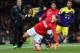 MANCHESTER, ENGLAND - JANUARY 05: Alexander Buttner of Manchester United tangles with Alejandro Pozuelo of Swansea City during the FA Cup with Budweiser Third round match between Manchester United and Swansea City at Old Trafford on January 5, 2014 in M