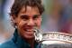 PARIS, FRANCE - JUNE 09: Rafael Nadal of Spain bites the Coupe des Mousquetaires trophy as he celebrates after the men's singles final against David Ferrer of Spain during day fifteen of the French Open at Roland Garros on June 9, 2013 in Paris, France.