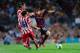 BARCELONA, SPAIN - AUGUST 28: Lionel Messi of FC Barcelona duels for the ball with Koke Resurreccion (L) and Filipe Luis of Atletico de Madrid during the Spanish Super Cup second leg match between FC Barcelona and Atletico de Madrid at Nou Camp on August