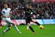 SWANSEA, WALES - JANUARY 01: Swansea defender Chico Flores (l) looks on as Edin Dzeko gets in a shot during the Barclays Premier League match between Swansea City and Manchester City at Liberty Stadium on January 1, 2014 in Swansea, Wales. (Photo by Stu