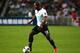 SO KON PO, HONG KONG - JULY 24: Jermain Defoe of Tottenhan Hotspur controls the ball during the Barclays Asia Trophy Semi Final match between Tottenham Hotspur and Sunderland at Hong Kong Stadium on July 24, 2013 in So Kon Po, Hong Kong. (Photo by Robert
