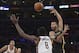 Dec 31, 2013; Los Angeles, CA, USA; Los Angeles Lakers guard Kendall Marshall (12) is defended by Milwaukee Bucks center Larry Sanders (8) during the game at Staples Center. The Bucks defeated the Lakers 94-79. Mandatory Credit: Kirby Lee-USA TODAY Sports