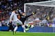 MADRID, SPAIN - SEPTEMBER 28: Alvaro Morata of Real Madrid CF shoots towards goal under a challenge by Thibaut Courtois of Atletico de Madrid during the La Liga match between Real Madrid CF and Club Atletico de Madrid at Bernabeu on September 28, 2013 in
