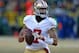 GREEN BAY, WI - JANUARY 05: Colin Kaepernick #7 of the San Francisco 49ers rolls out to look for a receiver against the Green Bay Packers during an NFC Wild Card Playoff game at Lambeau Field on January 5, 2014 in Green Bay, Wisconsin. The 49ers defeated