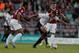 NORTHAMPTON, ENGLAND - AUGUST 06: Dele Alli of MK Dons attempts to move away with the ball from Joe Widdowson of Northampton Town during the Capital One Cup First Round match between Northampton Town and MK Dons at Sixfields Stadium on August 6, 2013 in