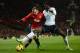 MANCHESTER, ENGLAND - JANUARY 01: Emmanuel Adebayor of Tottenham Hotspur battles for the ball with Wayne Rooney of Manchester United during the Barclays Premier League match between Manchester United and Tottenham Hotspur at Old Trafford on January 1, 20