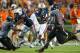AUBURN, AL - SEPTEMBER 7: Runningback Cameron Artis-Payne #44 of the Auburn Tigers runs through traffic during their game against the Arkansas State Red Wolves on September 7, 2013 at Jordan-Hare Stadium in Auburn, Alabama. Auburn defeated Arkansas Stat