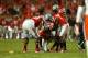 MIAMI GARDENS, FL - JANUARY 03: Braxton Miller #5 of the Ohio State Buckeyes is helped up by teammates after a play in the fourth quarter against the Clemson Tigers during the Discover Orange Bowl at Sun Life Stadium on January 3, 2014 in Miami Gardens, F