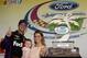HOMESTEAD, FL - NOVEMBER 17: Denny Hamlin, driver of the #11 FedEx Express Toyota, celebrates in victory lane with his daughter Taylor and Jordan Fish after winning the NASCAR Sprint Cup Series Ford EcoBoost 400 at Homestead-Miami Speedway on November 17