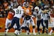 DENVER, CO - DECEMBER 12: Quarterback Peyton Manning #18 of the Denver Broncos is swarmed by defensive end Kendall Reyes #91 and linebacker Thomas Keiser #90 of the San Diego Chargers as he throws a pass during a game at Sports Authority Field Field at