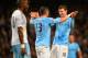 MANCHESTER, ENGLAND - JANUARY 08: Edin Dzeko of Manchester City celebrates scoring their sixth goal with Aleksandar Kolarov of Manchester City during the Capital One Cup Semi-Final first leg match between Manchester City and West Ham United at Etihad Sta