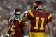 PASADENA, CA - JANUARY 04: Reggie Bush #5 walks past quarterback Matt Leinart #11 of the USC Trojans during the first half of the BCS National Championship Rose Bowl Game against the Texas Longhorns at the Rose Bowl on January 4, 2006 in Pasadena, Califo