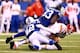 INDIANAPOLIS, IN - JANUARY 04: Quarterback Alex Smith #11 of the Kansas City Chiefs is tackled by outside linebacker Erik Walden #93 and defensive back Corey Lynch #42 of the Indianapolis Colts during a Wild Card Playoff game at Lucas Oil Stadium on Janua