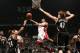NEW YORK, NY - JANUARY 10: Norris Cole #30 of the Miami Heat shoots against Andrei Kirilenko #47 and Paul Pierce #34 of the Brooklyn Nets during a game at the Barclays Center on January 10, 2014 in the Brooklyn borough of New York City. NOTE TO USER: Use