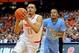 Jan 11, 2014; Syracuse, NY, USA; Syracuse Orange guard Tyler Ennis (11) drives to the basket past North Carolina Tar Heels guard Nate Britt (0) during the first half at the Carrier Dome. Mandatory Credit: Rich Barnes-USA TODAY Sports