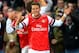 LONDON, ENGLAND - DECEMBER 08: Mesut Oezil of Arsenal celebrates scoring their first goal with team mates during the Barclays Premier League match between Arsenal and Everton at Emirates Stadium on December 8, 2013 in London, England. (Photo by Michael
