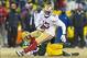 Jan 5, 2014; Green Bay, WI, USA; San Francisco 49ers wide receiver Michael Crabtree (15) is tackled by Green Bay Packers cornerback Jarrett Bush (24) after catching a pass during the fourth quarter of the 2013 NFC wild card playoff football game at Lambea