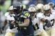 Jan 11, 2014; Seattle, WA, USA; Seattle Seahawks running back Marshawn Lynch (24) runs the football against New Orleans Saints strong safety Roman Harper (41) during the second half of the 2013 NFC divisional playoff football game at CenturyLink Field. Ma