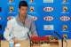MELBOURNE, AUSTRALIA - JANUARY 12: Novak Djokovic of Serbia about to hand out chocolate to the media after his press conference ahead of the 2014 Australian Open at Melbourne Park on January 12, 2014 in Melbourne, Australia. (Photo by Vince Caligiuri/Ge