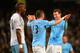 MANCHESTER, ENGLAND - JANUARY 08: Edin Dzeko of Manchester City celebrates scoring their sixth goal with Aleksandar Kolarov of Manchester City during the Capital One Cup Semi-Final first leg match between Manchester City and West Ham United at Etihad Sta