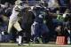 Jan 11, 2014; Seattle, WA, USA; Seattle Seahawks running back Marshawn Lynch (24) scores a touchdown against New Orleans Saints cornerback Keenan Lewis (28) during the second half of the 2013 NFC divisional playoff football game at CenturyLink Field. The