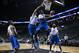 Nelson (blue) swoops to the tin with Williams (white) contesting the shot.