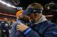 DENVER, CO - JANUARY 12: Head coach John Fox of the Denver Broncos and head coach Mike McCoy of the San Diego Chargers embrace after the Broncos defeated the Chargers 24 to 17 during the AFC Divisional Playoff Game at Sports Authority Field at Mile High