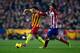 MADRID, SPAIN - JANUARY 11: Xavi Hernandez of FC Barcelona competes for the ball with Koke of Atletico de Madrid during the La Liga match between Club Atletico de Madrid and FC Barcelona at Vicente Calderon Stadium on January 11, 2014 in Madrid, Spain. (