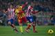 MADRID, SPAIN - JANUARY 11: Joao Miranda (R) of Atletico de Madrid steals the ball from Lionel Messi (2nd R) of FC Barcelona as Tiago Mendes (L) looks on during the La Liga match between Club Atletico de Madrid and FC Barcelona at Vicente Calderon Stadium