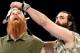 Luke Harper takes off Erick Rowan's mask.
