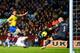 BIRMINGHAM, ENGLAND - JANUARY 13: Olivier Giroud of Arsenal scores their second goal past Brad Guzan of Aston Villa during the Barclays Premier League match between Aston Villa and Arsenal at Villa Park on January 13, 2014 in Birmingham, England. (Phot