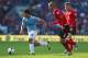 CARDIFF, WALES - AUGUST 25: Sergio Aguero (L) of Manchester City escapes from Matthew Connolly (C) and Aron Gunnarsson (R) of Cardiff City during the Barclays Premier League match between Cardiff City and Manchester City at Cardiff City Stadium on August