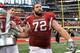 ARLINGTON, TX - OCTOBER 01: (L-R) DeQuinta Jones #92, Travis Swanson #64 and Grant Cook #72 of the Arkansas Razorbacks walk away with the Southwest Classic trophy after beating the Texas A&M Aggies at Cowboys Stadium on October 1, 2011 in Arlington, Texa