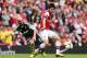 LONDON, ENGLAND - SEPTEMBER 22: Ryo Miyaichi of Arsenal evades Stephen Ireland of Stoke City during the Barclays Premier League match between Arsenal and Stoke City at Emirates Stadium on September 22, 2013 in London, England. (Photo by Ian Walton/Getty