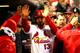ST LOUIS, MO - OCTOBER 27: Matt Carpenter #13 of the St. Louis Cardinals celebrates with his teammates in the dugout after scoring a run off of Carlos Beltran #3 singled to center field in the third inning against Clay Buchholz #11 of the Boston Red Sox