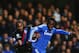 LONDON, ENGLAND - DECEMBER 14: (L-R) Cameron Jerome of Crystal Palace and Michael Essien of Chelsea challenge for the ball during the Barclays Premier League match between Chelsea and Crystal Palace at Stamford Bridge on December 14, 2013 in London, Engl