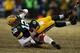 GREEN BAY, WI - JANUARY 05: Aaron Rodgers #12 of the Green Bay Packers gets sacked by Justin Smith #94 of the San Francisco 49ers during their NFC Wild Card Playoff game at Lambeau Field on January 5, 2014 in Green Bay, Wisconsin. (Photo by Jonathan Dan