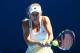 MELBOURNE, AUSTRALIA - JANUARY 14: Caroline Wozniacki of Denmark plays a backhand in her first round match against Lourdes Dominguez Lino of Spain during day two of the 2014 Australian Open at Melbourne Park on January 14, 2014 in Melbourne, Australia.