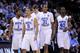 NEWARK, NJ - MARCH 25: Dexter Strickland #1, Kendall Marshall #5, John Henson #31 and Harrison Barnes #40 of the North Carolina Tar Heels walk on the court after a play against the Marquette Golden Eagles during the east regional semifinal of the 2011 N