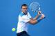 MELBOURNE, AUSTRALIA - JANUARY 14: Jack Sock of the United States plays a backhand in his first round match against Tobias Kamke of Germany during day two of the 2014 Australian Open at Melbourne Park on January 14, 2014 in Melbourne, Australia. (Photo