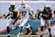 Dec 29, 2013; Miami Gardens, FL, USA; Miami Dolphins quarterback Ryan Tannehill (17) breaks free as New York Jets outside linebacker Calvin Pace (97) and linebacker Quinton Coples (98) chase during the second half of the game at Sun Life Stadium. The Jets