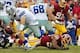 Dec 22, 2013; Landover, MD, USA; Dallas Cowboys quarterback Tony Romo (9) scrambles from Washington Redskins outside linebacker Rob Jackson (50) in the fourth quarter at FedEx Field. Romo was injured on the play and is out for the season. The Cowboys won