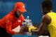 MELBOURNE, AUSTRALIA - JANUARY 16: Gael Monfils of France and a ball kid hold several water bottles during a break in his second round match against Jack Sock of the United States during day four of the 2014 Australian Open at Melbourne Park on January 1