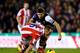 STOKE ON TRENT, ENGLAND - JANUARY 12: Charlie Adam of Stoke City battles with Steven Gerrard of Liverpool during the Barclays Premier League match between Stoke City and Liverpool at Britannia Stadium on January 12, 2014 in Stoke on Trent, England. (Pho