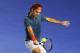 MELBOURNE, AUSTRALIA - JANUARY 08: Roger Federer of Switzerland hits a backhand in his match against Jo Wilfried Tsonga of France during the Roger Federer Charity match at Melbourne Park on January 8, 2014 in Melbourne, Australia. (Photo by Graham Denho