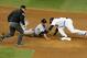 Oct 14, 2012; Bronx, NY, USA; Second base umpire Jeff Nelson (left) watches as Detroit Tigers second baseman Omar Infante (in grey) tries to dive back to second base against New York Yankees second baseman Robinson Cano in the 8th inning during game two o