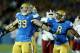 PASADENA, CA - SEPTEMBER 21: Defensive end Cassius Marsh #99 of the UCLA Bruins celebrates with linebacker Deon Hollins #8 after Marsh tackled quarterback King Davis III of the New Mexico State Aggies for a loss at the Rose Bowl on September 21, 2013 in