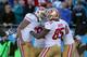 CHARLOTTE, NC - JANUARY 12: Colin Kaepernick #7 of the San Francisco 49ers celebrates with teammates after a touchdown in the third quarter against the Carolina Panthers during the NFC Divisional Playoff Game at Bank of America Stadium on January 12, 201